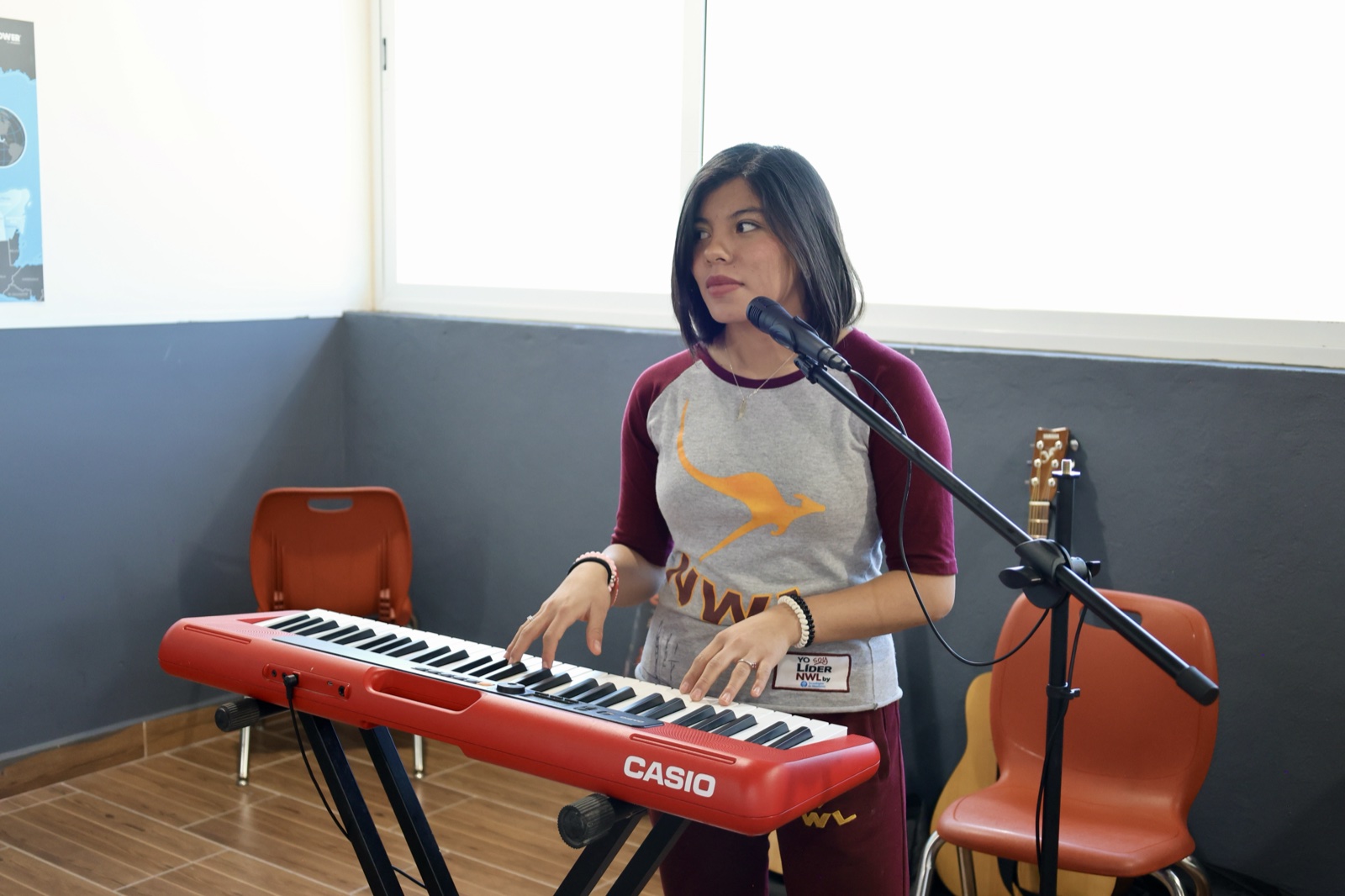 Student playing keyboard in music room