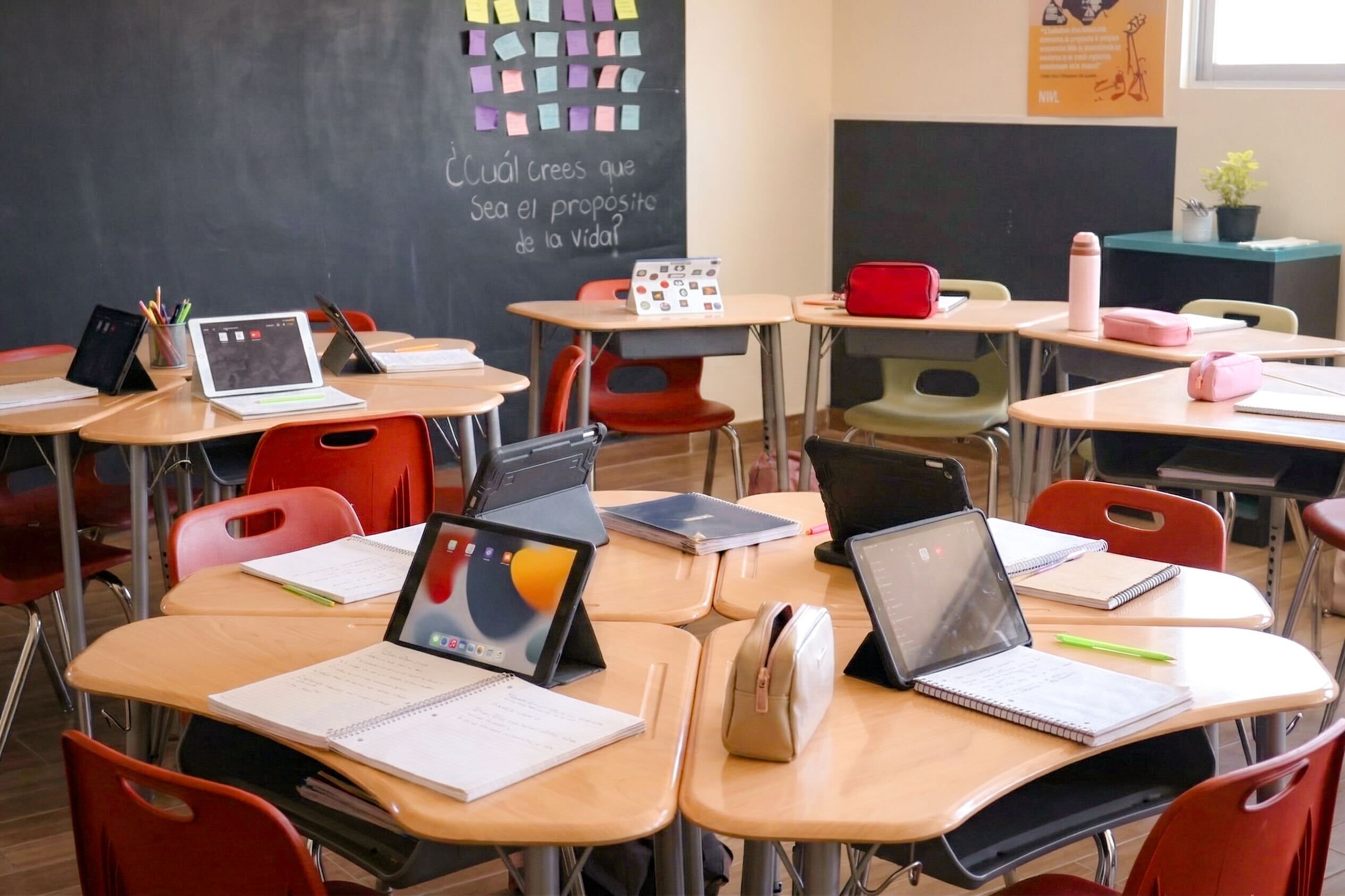 Newland Middle School modern classroom with round tables and iPads