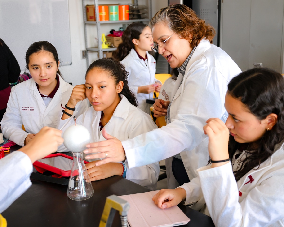 Newland Middle School students conducting science lab experiment with teacher guidance