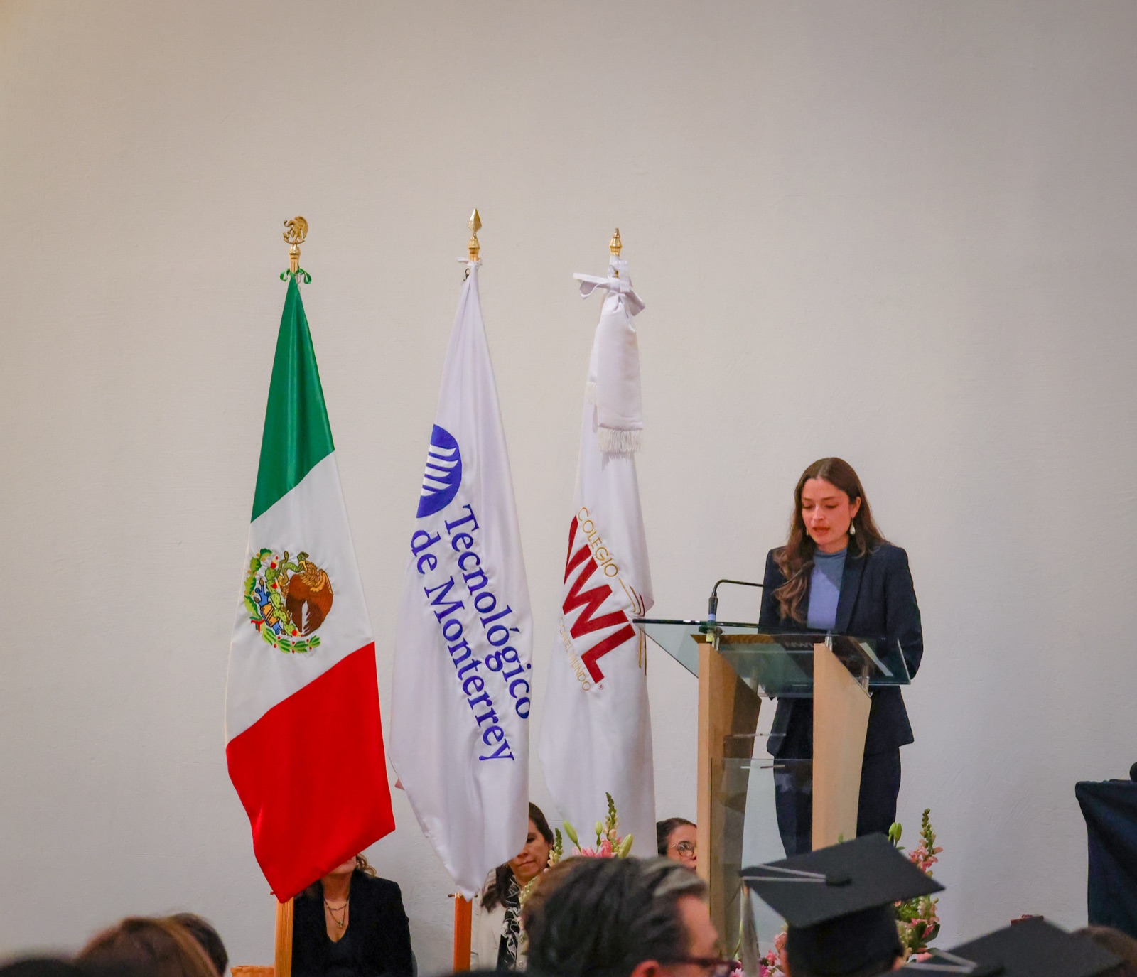 NWL student giving a speech at the podium during a school ceremony