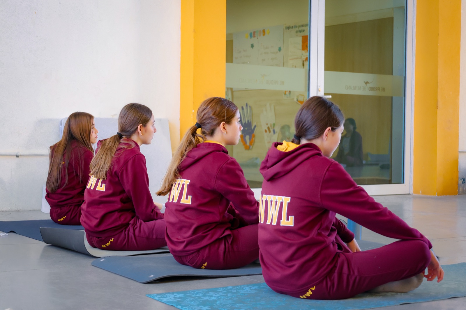 NWL students practicing yoga during a wellbeing session