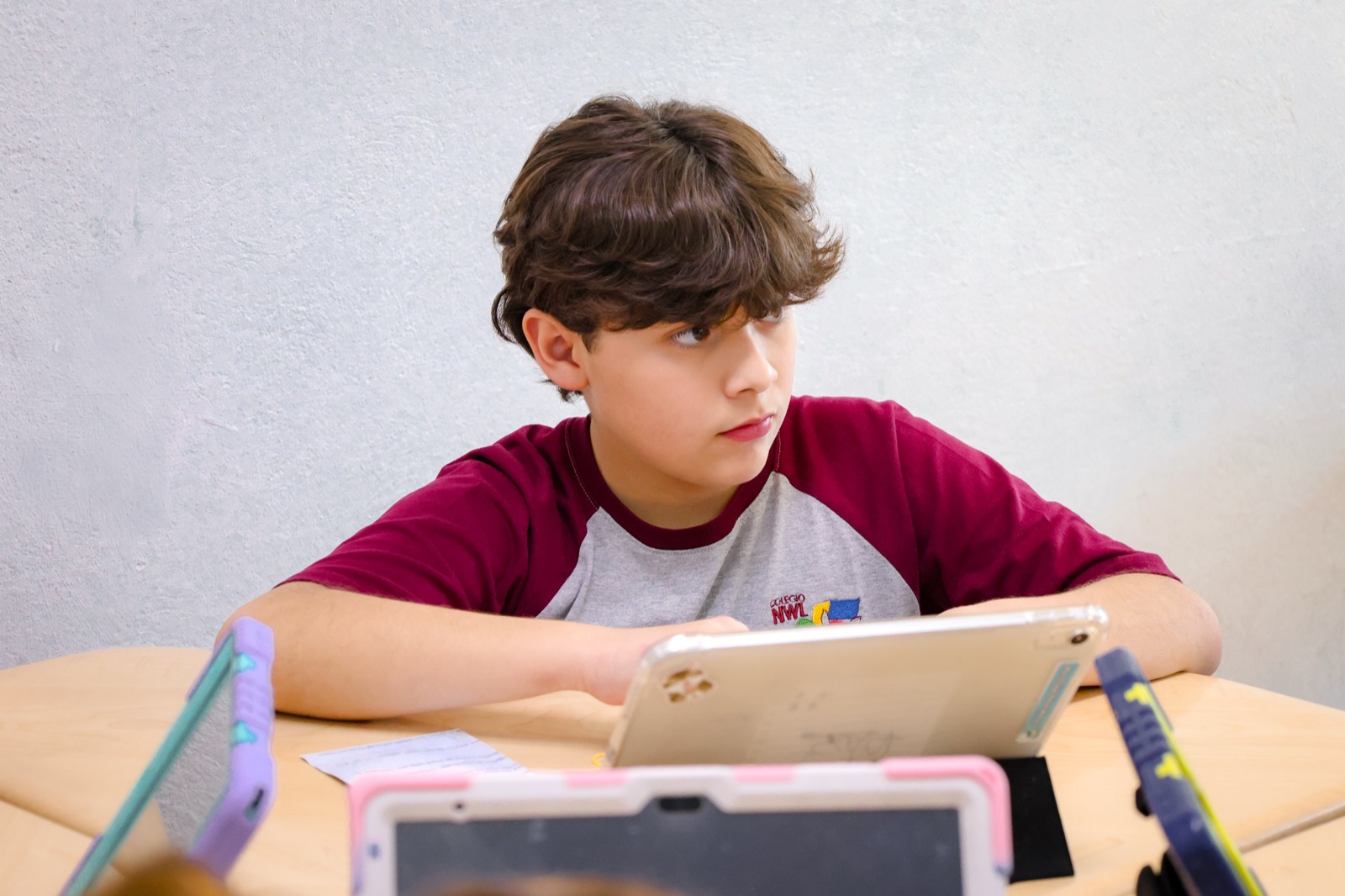 NWL student working on his iPad in the classroom